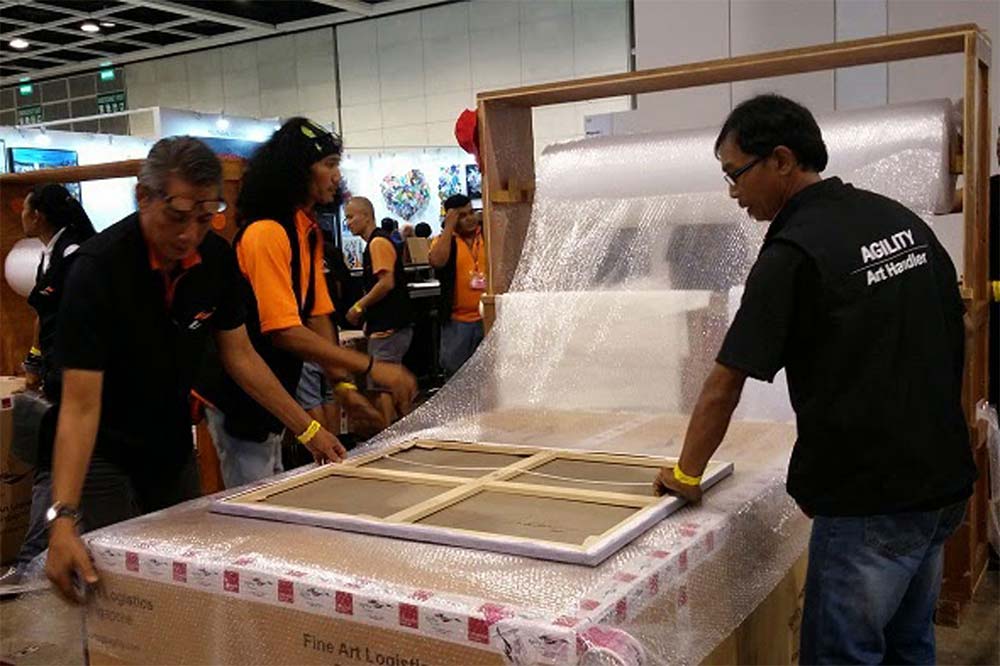 Staff from Agility support packing artwork at Affordable Art Fair