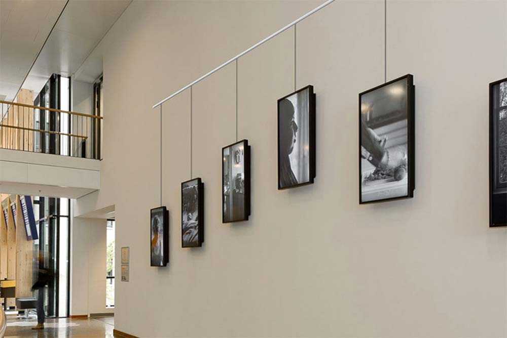 Pictures hung on the wall using the STAS picture hanging system
